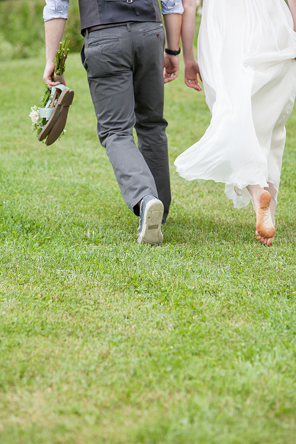 Barefoot wedding couple in the vineyard rows